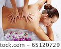 Young beautiful woman in spa environment 65120729