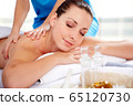 Young beautiful woman in spa environment 65120730