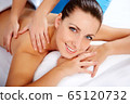 Young beautiful woman in spa environment 65120732