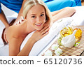 Young beautiful woman in spa environment 65120736