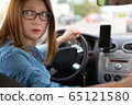 A woman driving the car backwards 65121580