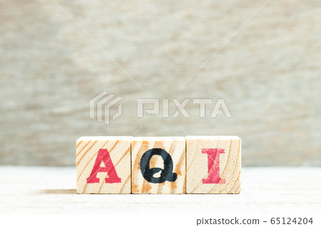 Alphabet letter in word AQI (Abbreviation of air quality index) on wood background Alphabet letter in word AQI (Abbreviation of air quality index) on wood background 65124204