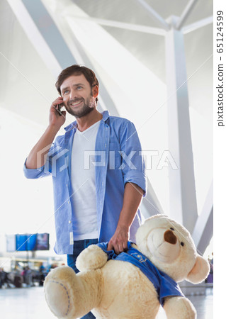 Portrait of man talking on smartphone while Portrait of man talking on smartphone while 65124599