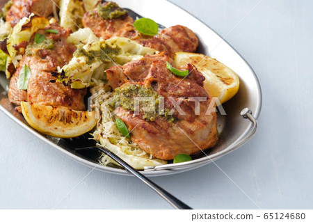 Grilled turkey steak with cabbage and herbs on a wooden background. Grilled turkey steak with cabbage and herbs on a wooden background. 65124680