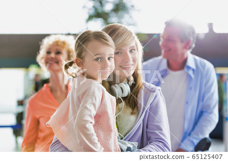 Portrait of young teenage girl carrying her cute Portrait of young teenage girl carrying her cute 65125407