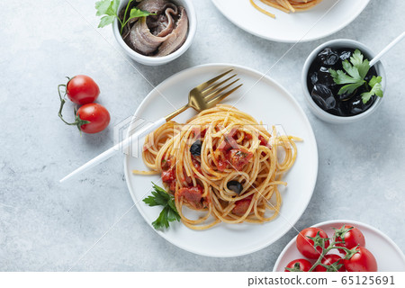 Traditional italian pasta puttanesca Traditional italian pasta puttanesca 65125691