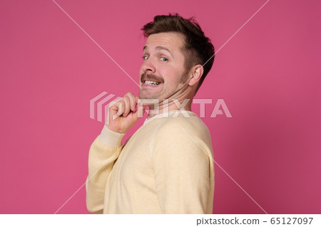 Young man in yellow shirt with a double chin. 65127097