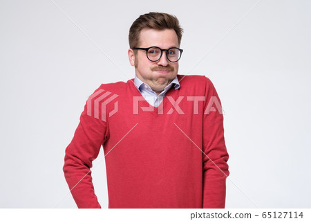 young man in glasses and red sweater isolated over young man in glasses and red sweater isolated over 65127114