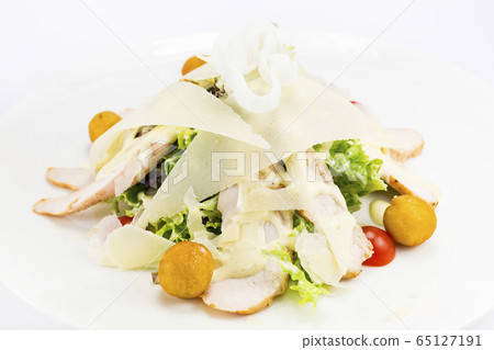 Warm salad of vegetables and meat. Close-up shot on a table in a restaurant. 65127191