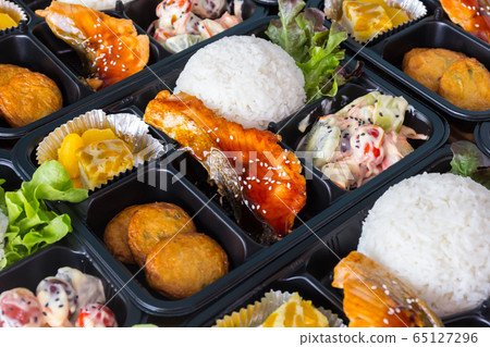 Asian lunch boxes in plastic packages. Asian lunch boxes in plastic packages. 65127296