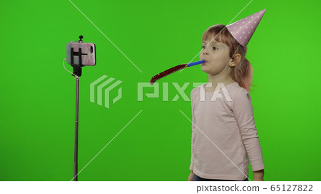 Girl child makes selfie vlog, blogging, video call on mobile phone using monopod 65127822