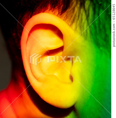 The ear of the boy in the light of the rainbow The ear of the boy in the light of the rainbow 65128645