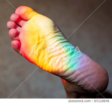 Man's foot in the color of the rainbow 65128646