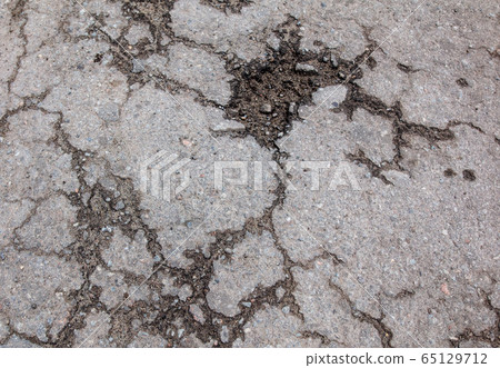 Cracks and pit on the asphalt road as background Cracks and pit on the asphalt road as background 65129712