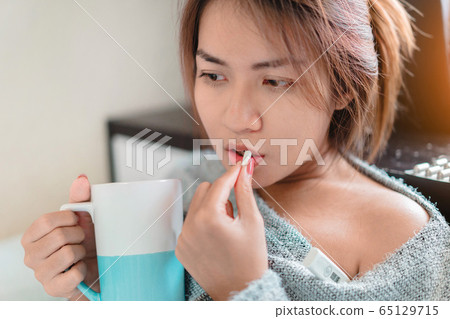 Sick asian woman have hight fever flu and take Sick asian woman have hight fever flu and take 65129715