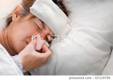 Sick asian woman have high fever flu and illness Sick asian woman have high fever flu and illness 65129799