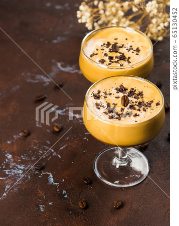 Frappe coffee in dessert glasses on brown backdrop 65130452