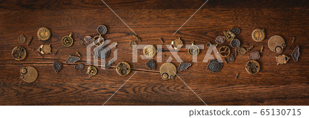 Mechanical cogwheel elements on a dark wooden Mechanical cogwheel elements on a dark wooden 65130715