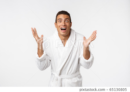 Hurray and cheers. Portrait of handsome shirtless young african american man looking excited while standing against white background Hurray and cheers. Portrait of handsome shirtless young african american man looking excited while standing against white background 65130805
