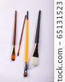Art brushes of different sizes on a white background. Four painting brushes, vertical shot 65131523
