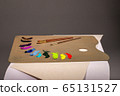 Oil painting. Palette with paints and brushes. The main tool of artist. Squeeze out oil paints on a palette and pieces of canvas. 65131527