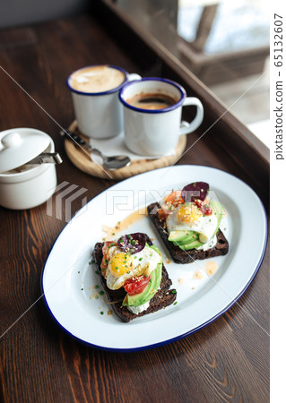Breakfast rye toast with avocado poched egg salmon 65132607
