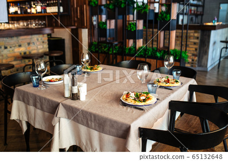 Nice served table with italian pizza and glass  65132648