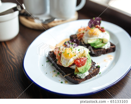 Breakfast rye toast with avocado poched egg salmon Breakfast rye toast with avocado poched egg salmon 65133103