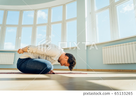 Man practice yoga. Young attractive male doing breathing exercises