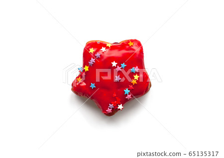 Red donut with colorful sprinkles on isolated background. Red donut with colorful sprinkles on isolated background. 65135317