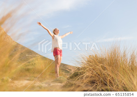 Free Happy Woman Enjoying Sun on Vacations. 65135854