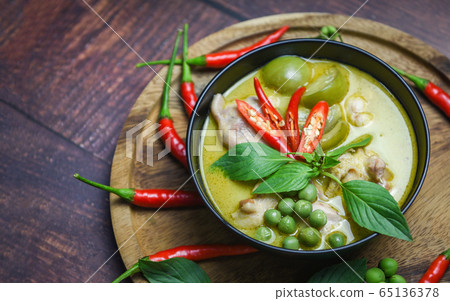 Thai food green curry on soup bowl with ingredient Thai food green curry on soup bowl with ingredient 65136378