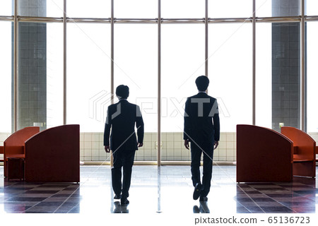 Silhouette of a businessman waiting at the lounge Silhouette of a businessman waiting at the lounge 65136723