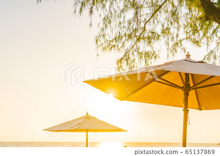 Umbrella and chair around beach sea ocean at sunset or sunrise time 65137869