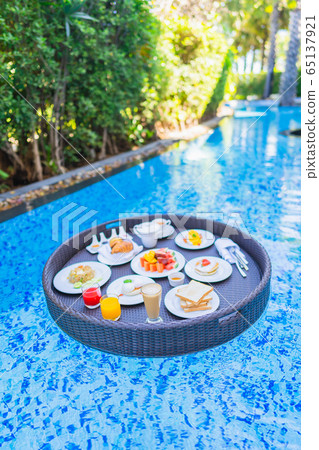 Floating breakfast set in tray with fried egg omelette sausage ham bread fruit milk juice coffee Floating breakfast set in tray with fried egg omelette sausage ham bread fruit milk juice coffee 65137921