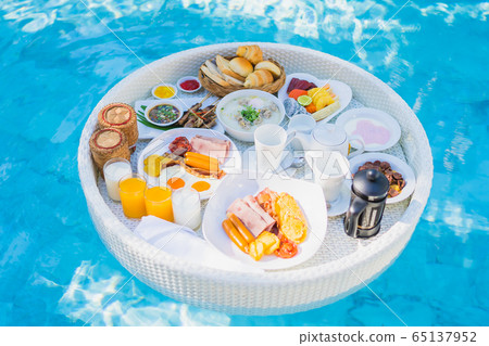 Floating breakfast set in tray with fried egg omelette sausage ham bread fruit milk juice coffee Floating breakfast set in tray with fried egg omelette sausage ham bread fruit milk juice coffee 65137952