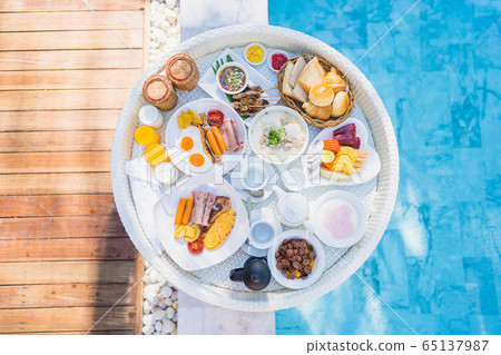Floating breakfast set in tray with fried egg omelette sausage ham bread fruit milk juice coffee Floating breakfast set in tray with fried egg omelette sausage ham bread fruit milk juice coffee 65137987