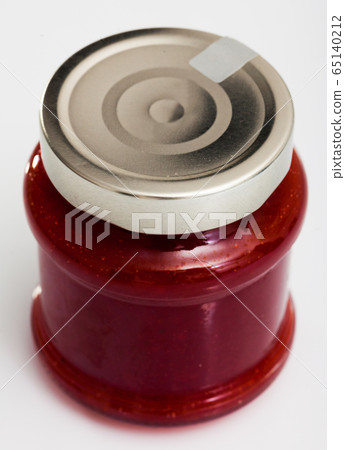 Strawberry jam in a glass jar 65140212