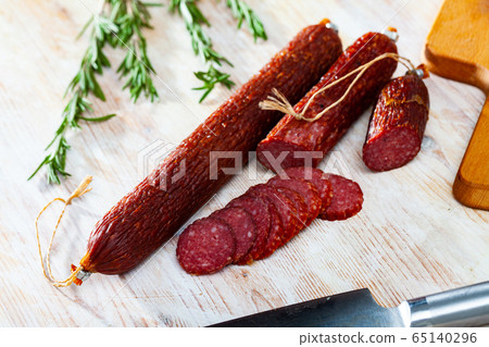 Smoked sausage on wooden surface Smoked sausage on wooden surface 65140296