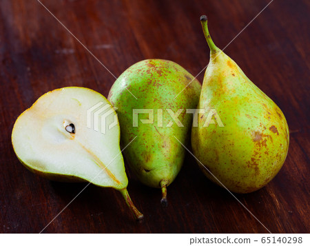 Cutted pears on wooden table Cutted pears on wooden table 65140298