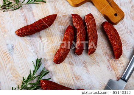 Roasted chezh sausages susena on cutting board Roasted chezh sausages susena on cutting board 65140353