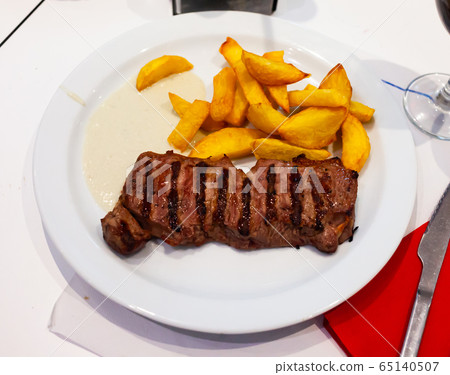 Tasty beef steak with baked potatoes and roquefort Tasty beef steak with baked potatoes and roquefort 65140507