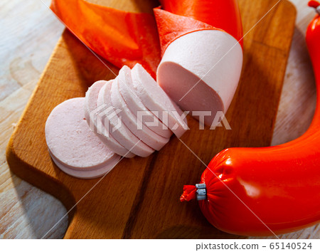 Appetizing boiled sausage mortadella on wooden table Appetizing boiled sausage mortadella on wooden table 65140524