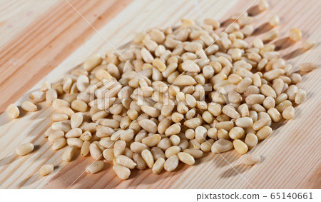 Picture of raw pine nut on the wooden desk, nobody 65140661