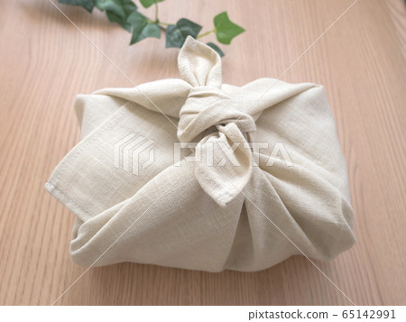 Bento wrapped in a furoshiki wrapped on a table Bento wrapped in a furoshiki wrapped on a table 65142991