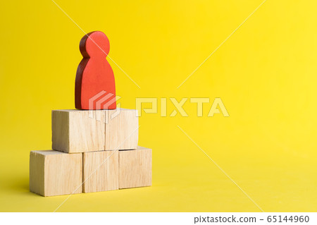 Red wood figure Stand on wood stack in human resource management or politics concepts, Teamwork Success Leadership Business Progress, Competition on yellow backgrond and copy space 65144960