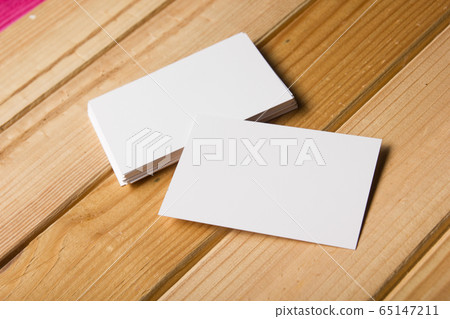 Business card blank on wooden background. Corporate Stationery, Branding Mock-up. Creative designer desk. Flat lay. Copy space for text 65147211