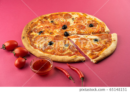 pizza close-up, isolated, against a colored background. whole pizza  65148151