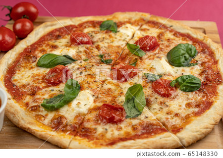pizza close-up, isolated, against a colored background. whole pizza  65148330