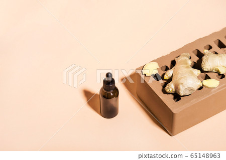 Organic Ginger essential oil in dark glass bottle, 65148963